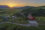 Experience breathtaking sunset views from this stunning property nestled in a serene mountain landscape.