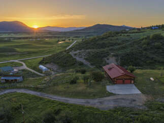 Experience breathtaking sunset views from this stunning property nestled in a serene mountain landscape.