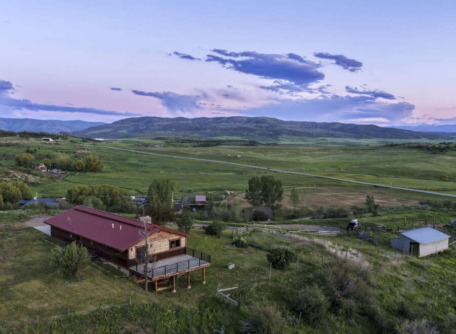Experience serene mountain living with this stunning property featuring a charming log cabin and expansive acreage.