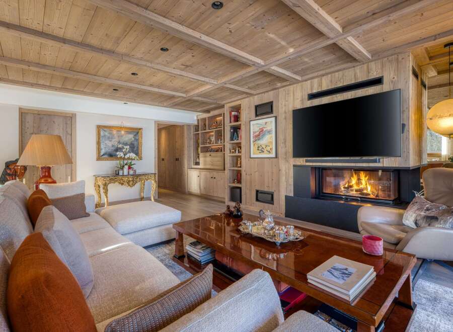 Experience the epitome of luxury living in this stunning property, featuring exquisite wooden accents and a cozy fireplace.