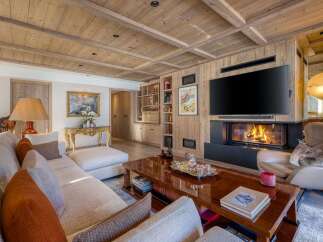 Experience the epitome of luxury living in this stunning property, featuring exquisite wooden accents and a cozy fireplace.