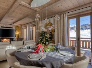 Experience luxury living in this stunning property, featuring a cozy fireplace and a beautifully decorated dining area perfect for entertaining.