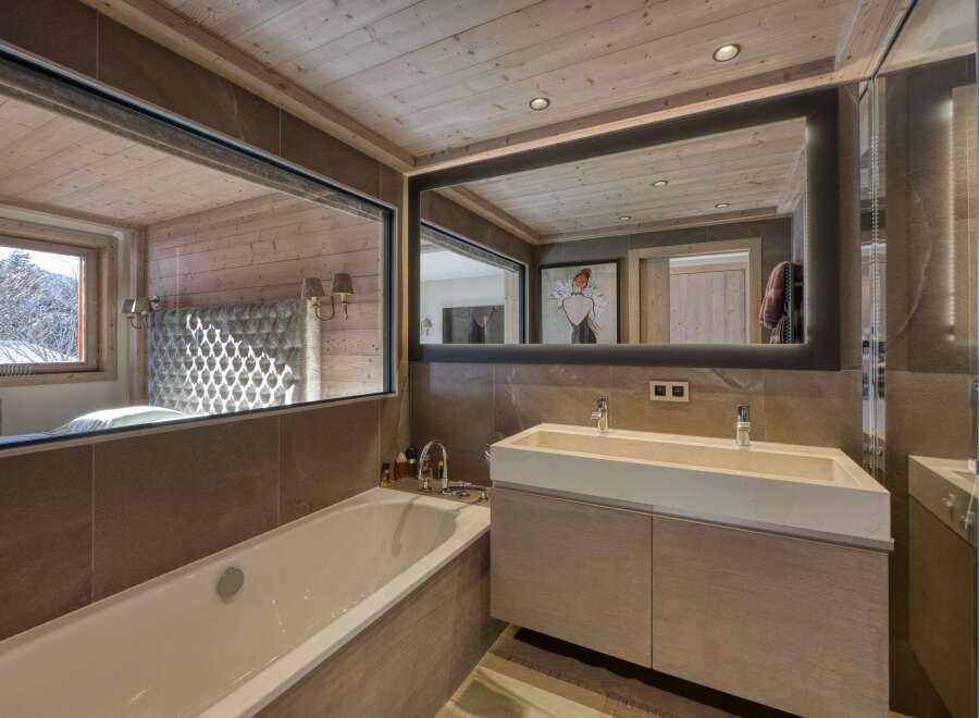 This luxurious bathroom features a modern design with a touch of rustic charm.