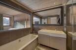 This luxurious bathroom features a modern design with a touch of rustic charm.