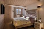 This stunning bedroom showcases a blend of rustic charm and modern elegance, perfect for a luxurious retreat.