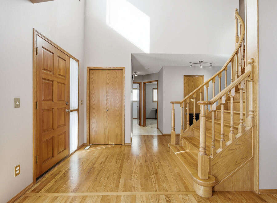 Step into this inviting entryway with stunning hardwood floors and a grand staircase.