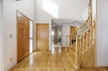 Step into this inviting entryway with stunning hardwood floors and a grand staircase.