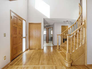 Step into this inviting entryway with stunning hardwood floors and a grand staircase.