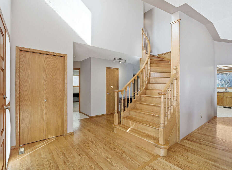 Step into this inviting home featuring a stunning staircase and beautiful hardwood floors.