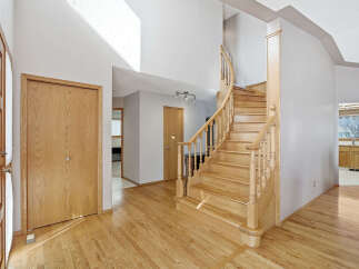 Step into this inviting home featuring a stunning staircase and beautiful hardwood floors.