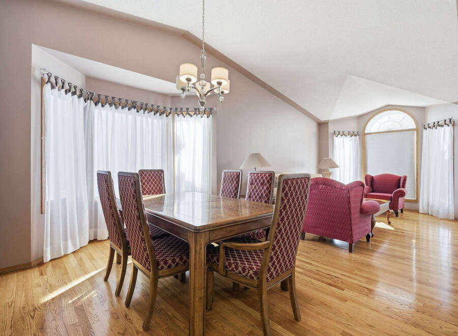 This elegant dining room boasts a beautiful wooden table and chairs, perfect for hosting dinner parties.