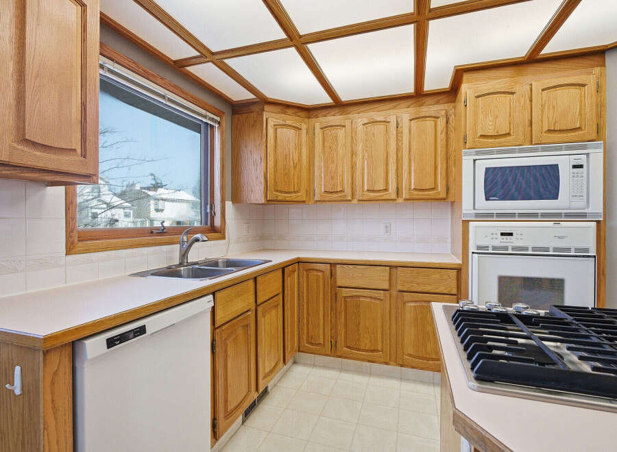 This charming kitchen boasts beautiful wooden cabinetry and a bright, inviting atmosphere.