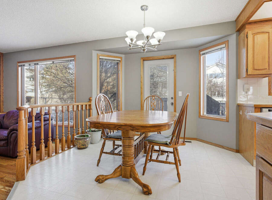 This inviting dining area features a beautiful wooden table and chairs, perfect for family gatherings.