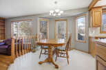 This inviting dining area features a beautiful wooden table and chairs, perfect for family gatherings.