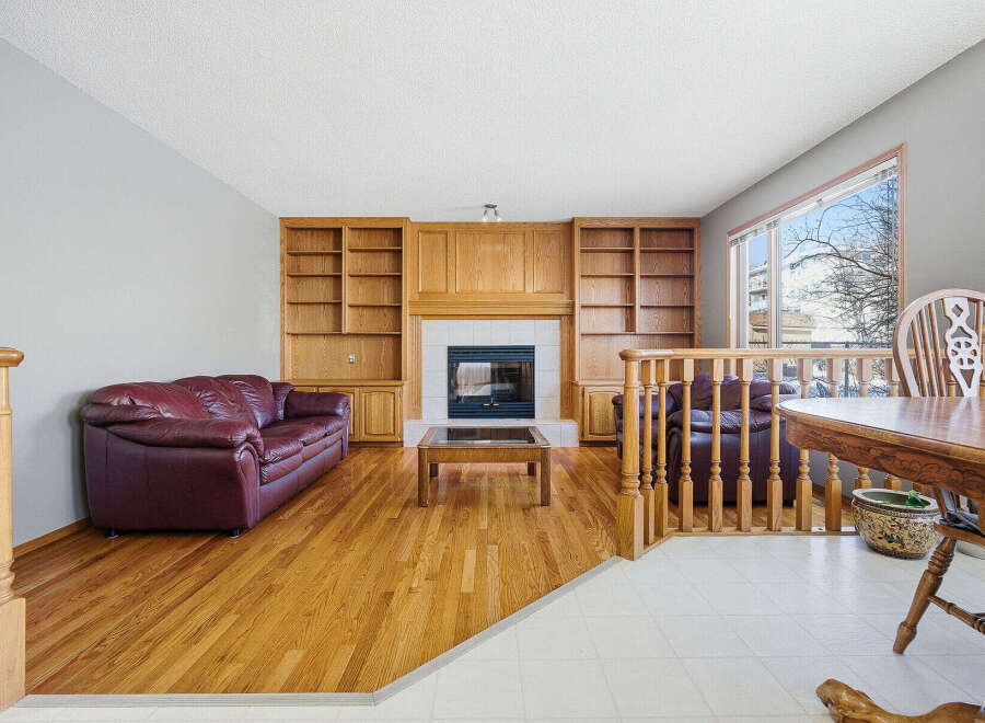 Step into this inviting living space, featuring a cozy fireplace and built-in shelving, perfect for showcasing your favorite decor.
