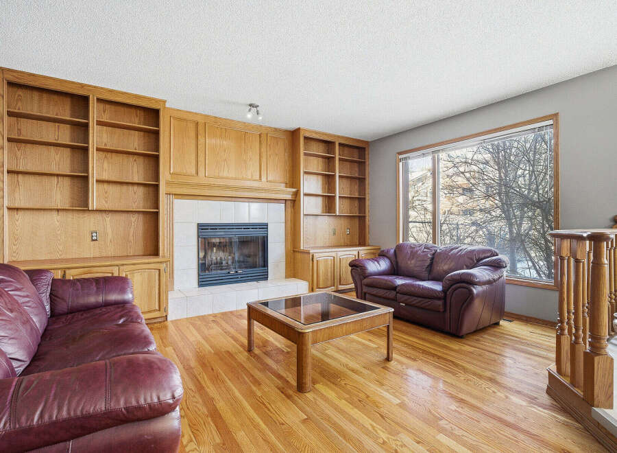 This stunning living room boasts a cozy fireplace, perfect for those chilly evenings.