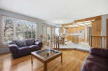 This stunning property boasts a spacious living area with hardwood floors and a cozy leather sofa, perfect for relaxing.