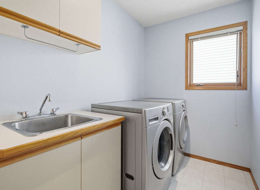 This laundry room offers a functional and organized space for all your washing needs.
