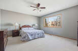 This spacious bedroom offers a serene retreat with its neutral color palette and ample natural light.