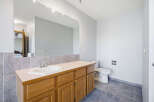 This spacious bathroom features a large vanity with ample storage, perfect for keeping your essentials organized.