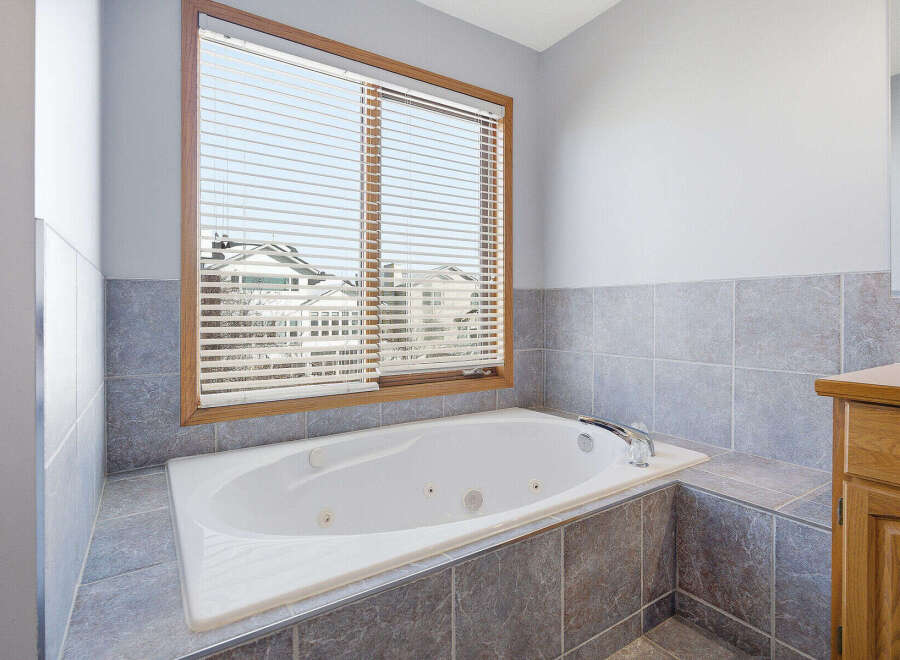 This luxurious bathroom features a relaxing jacuzzi tub, perfect for unwinding after a long day.