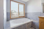 This luxurious bathroom features a relaxing jacuzzi tub, perfect for unwinding after a long day.