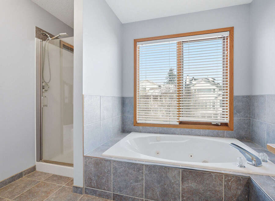 This luxurious bathroom features a relaxing jacuzzi tub, perfect for unwinding after a long day.