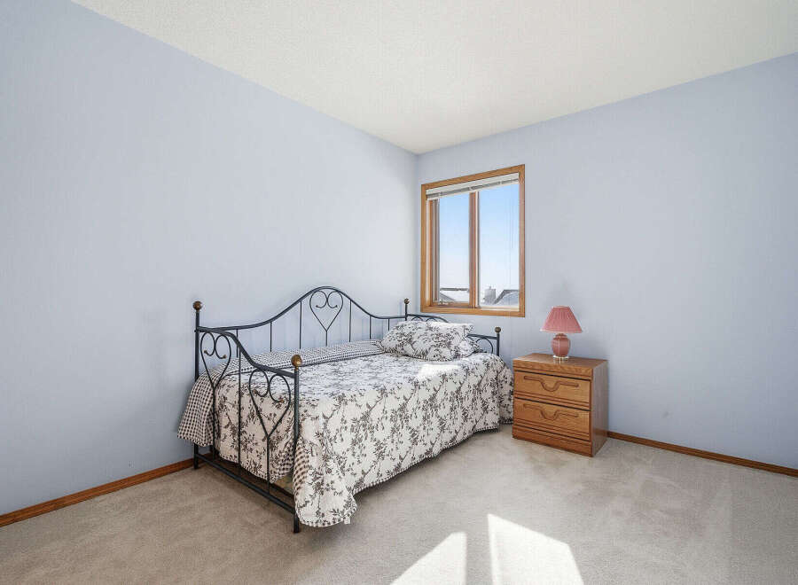 This charming bedroom features a cozy daybed, perfect for relaxing or hosting guests.