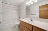 This bathroom features a clean and bright design with white tile and a neutral color palette.