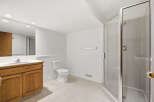This spacious bathroom features a modern design with a walk-in shower and a sleek vanity.