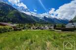 Discover your dream home with breathtaking mountain views! This stunning property offers a serene escape with lush green surroundings and charming houses.