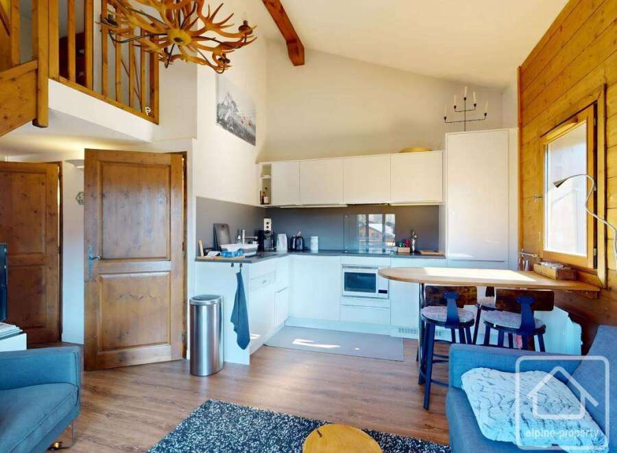 Discover the charm of this stunning property, featuring a modern kitchen with sleek white cabinetry and essential appliances.