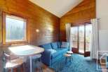 Discover the charm of this cozy cabin-style property, featuring warm wooden interiors and a welcoming atmosphere.