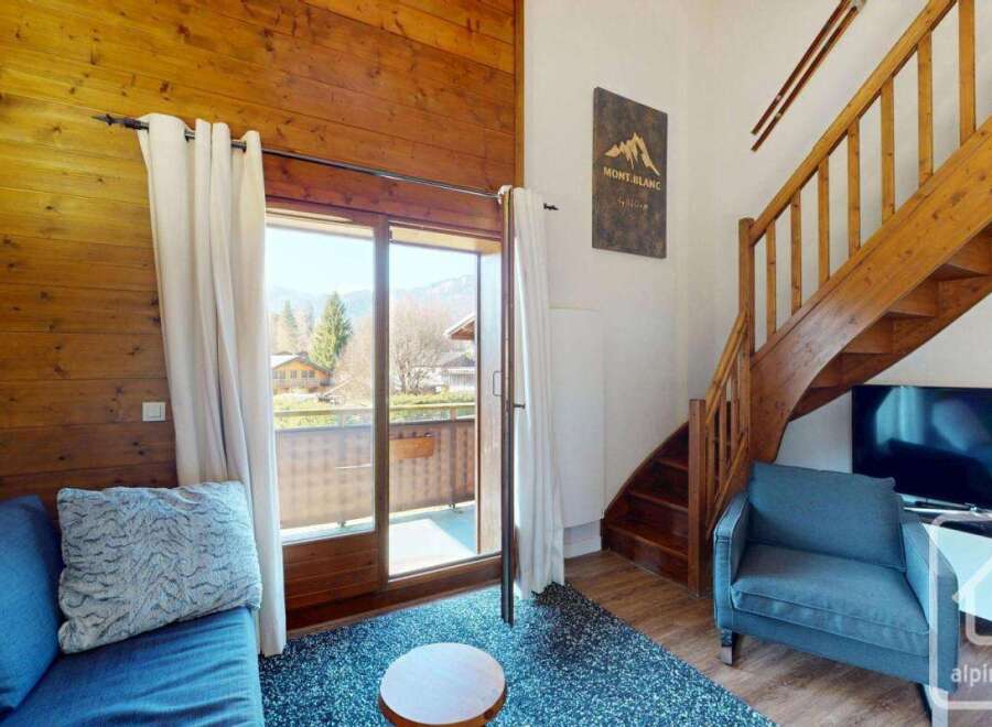 Discover the charm of this cozy mountain retreat! This property features a stunning wooden interior, a comfortable seating area, and a balcony with breathtaking views.