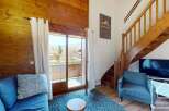 Discover the charm of this cozy mountain retreat! This property features a stunning wooden interior, a comfortable seating area, and a balcony with breathtaking views.
