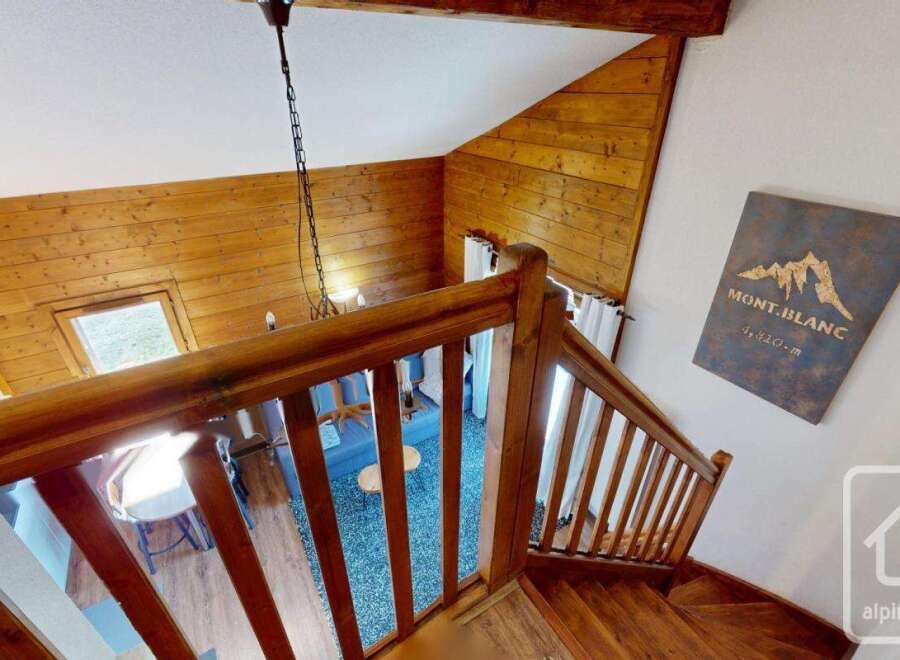 Discover the charm of this stunning property, featuring a beautifully crafted wooden staircase and a cozy interior.
