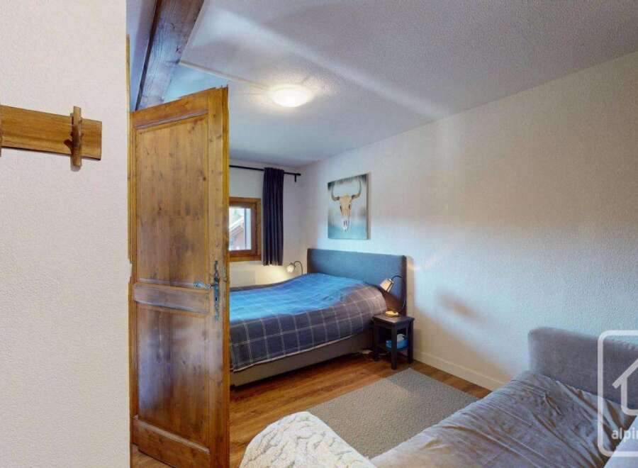 Discover the charm of this cozy bedroom, featuring a comfortable bed and a stylish design.