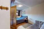 Discover the charm of this cozy bedroom, featuring a comfortable bed and a stylish design.