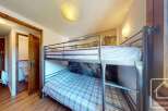 This cozy bedroom features a bunk bed, perfect for accommodating guests or family members.