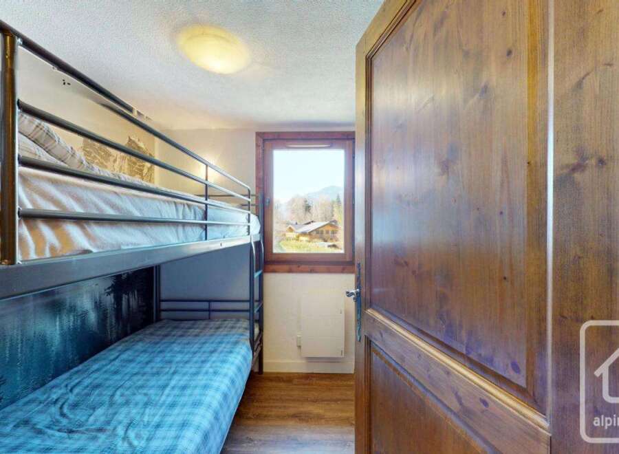 Discover this charming property featuring a cozy bunk bed setup, perfect for accommodating guests or family.