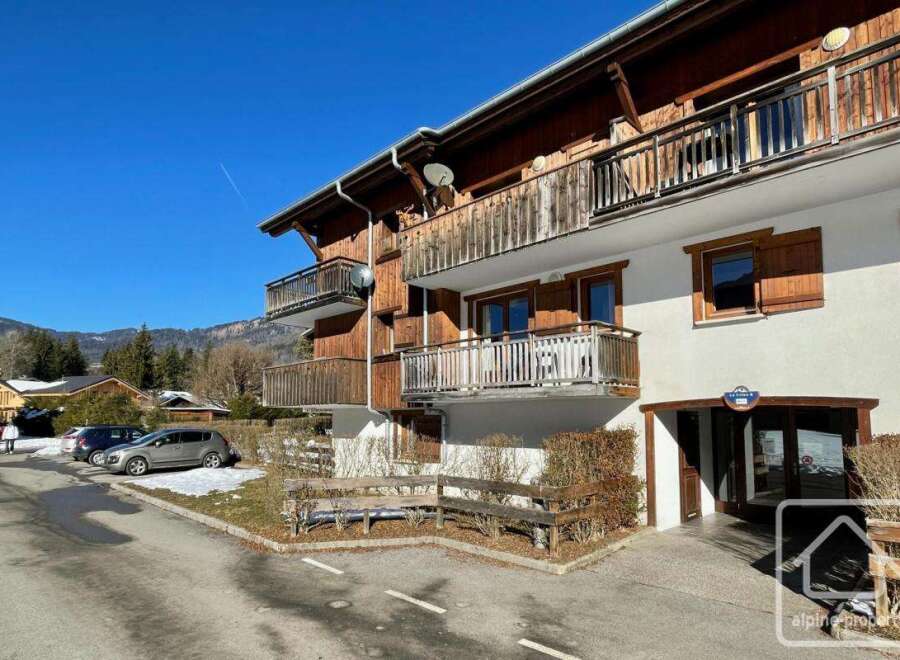Discover a charming alpine property with stunning wooden balconies and a welcoming entrance.