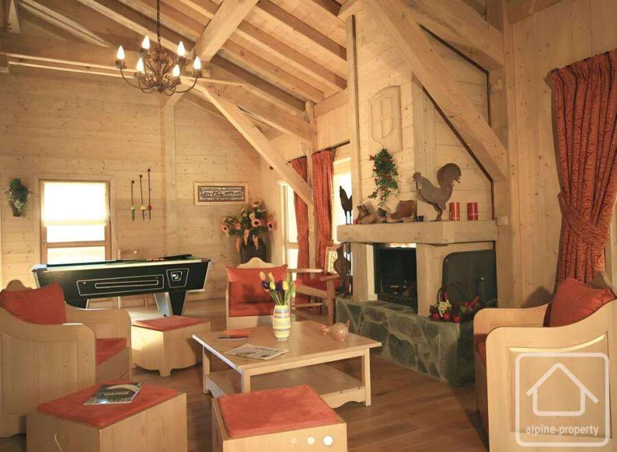 This stunning property boasts a cozy living room with a rustic fireplace, perfect for relaxing evenings.