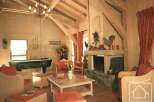 This stunning property boasts a cozy living room with a rustic fireplace, perfect for relaxing evenings.