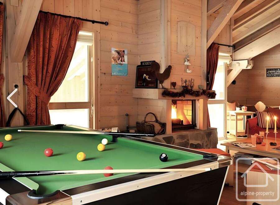 This stunning property boasts a cozy living space with a pool table, perfect for entertaining guests.