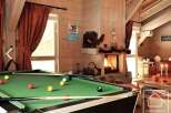 This stunning property boasts a cozy living space with a pool table, perfect for entertaining guests.
