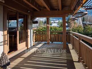 Enjoy breathtaking mountain views from this stunning wooden deck.