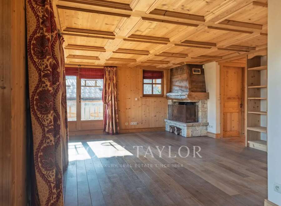 This stunning property boasts a warm and inviting interior with beautiful wooden features throughout.