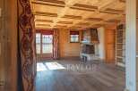 This stunning property boasts a warm and inviting interior with beautiful wooden features throughout.