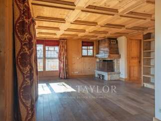 This stunning property boasts a warm and inviting interior with beautiful wooden features throughout.