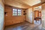 Step into this inviting space, showcasing a warm wooden interior and a bright window offering scenic views.